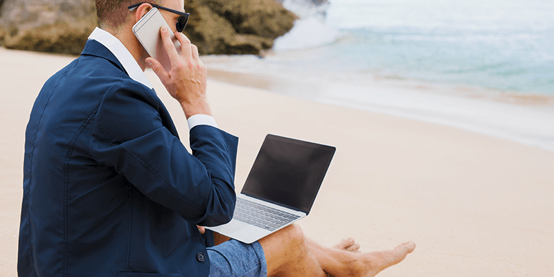 business man on beach on important call